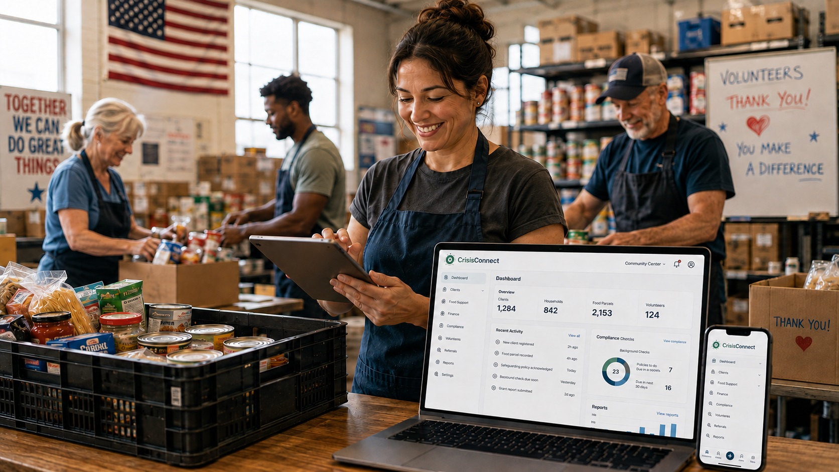 Volunteers running a community food pantry in the US, with CrisisConnect open on a laptop, tablet and phone